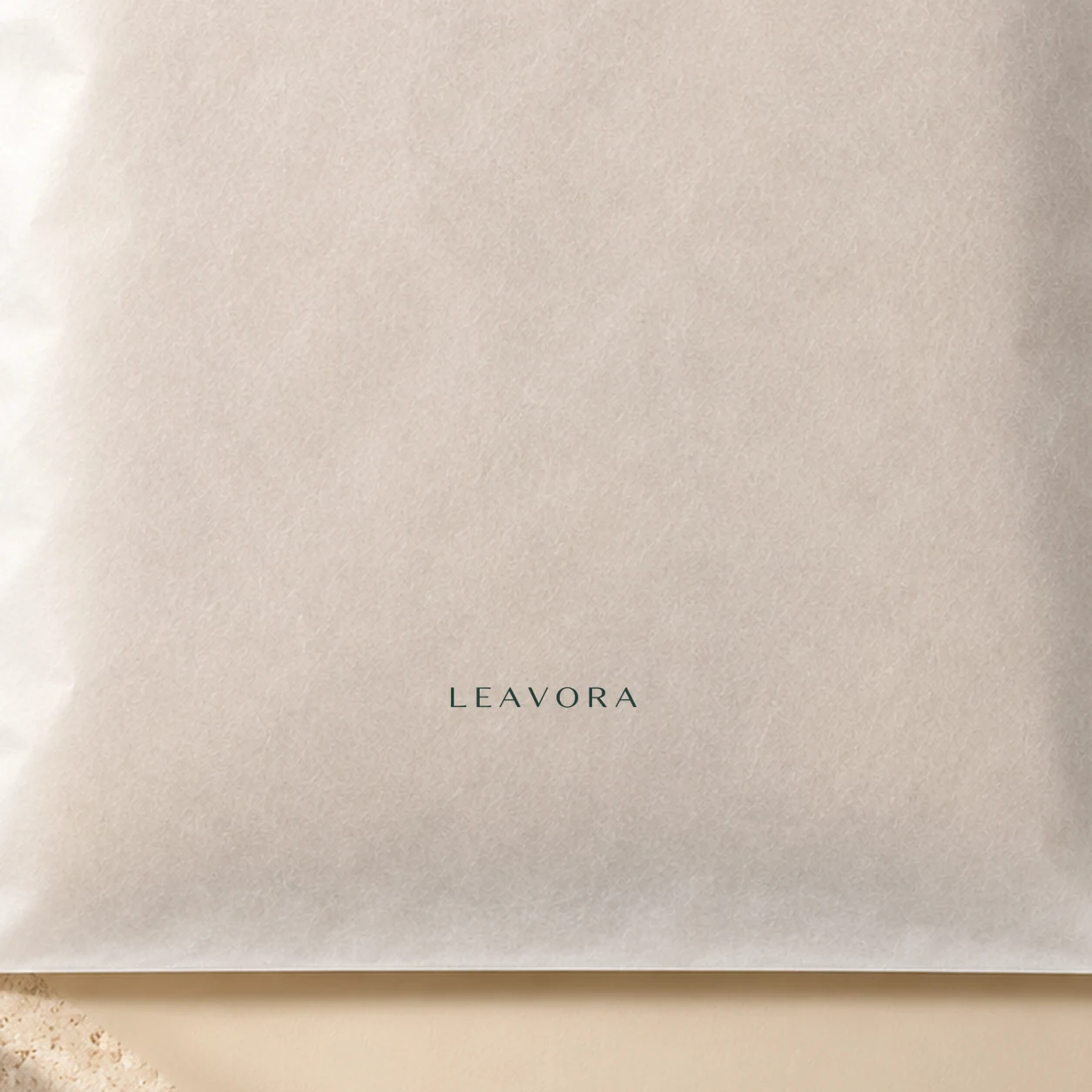Close-up concept of restrained LEAVORA print on translucent glassine.